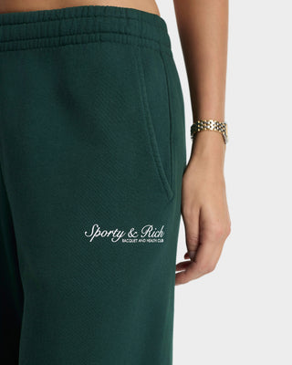 Green sweatpants with 'Sporty & Rich' logo on a white background
