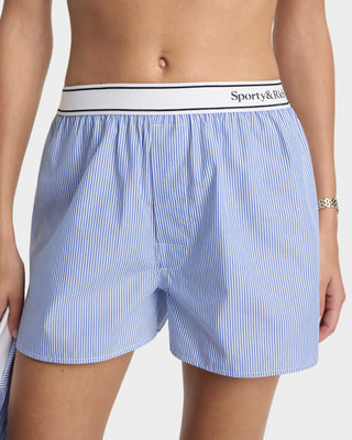 Blue striped boxer shorts with a white waistband featuring 'Sporty & Rich' branding on a plain background.