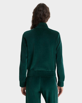 Person wearing a green tracksuit on a white background