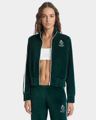 Woman wearing a green tracksuit with a logo on a white background
