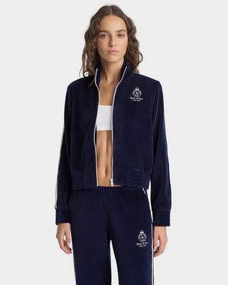 Person wearing a navy tracksuit with a brand logo on a white background