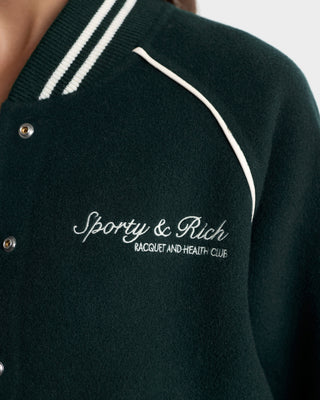 Dark green cardigan with white piping and 'Sporty & Rich' logo on a light gray background