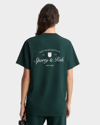 Person wearing a green t-shirt with 'Sporty & Rich' logo on the back