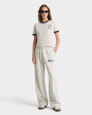 Woman wearing a Yale-themed outfit on a white background