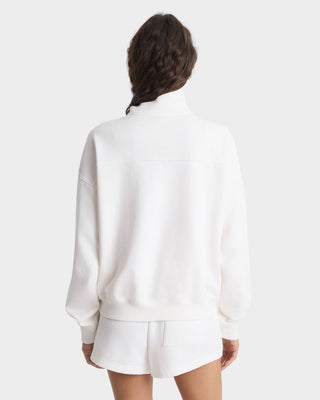 Person wearing a white outfit on a plain background