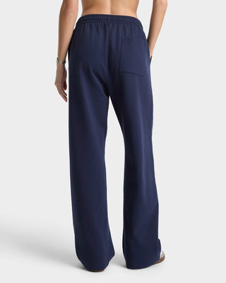 Navy blue pants worn by a person on a white background