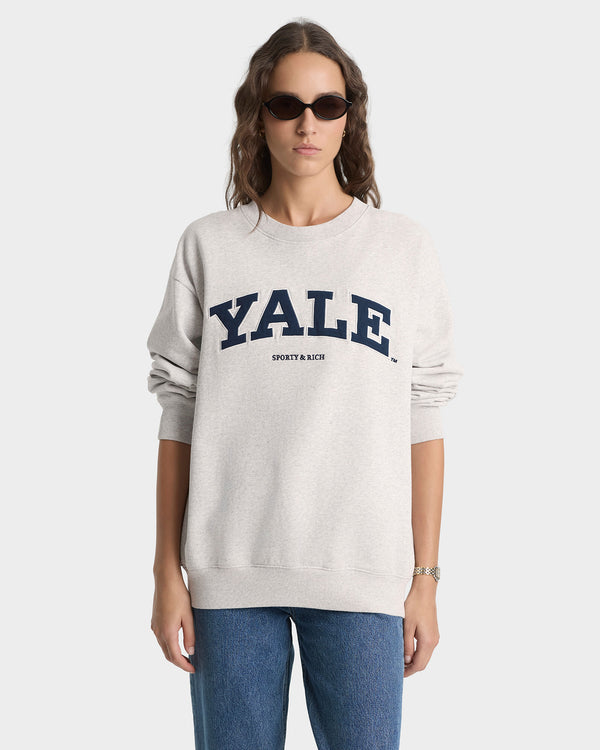 Person wearing a Yale sweatshirt on a white background