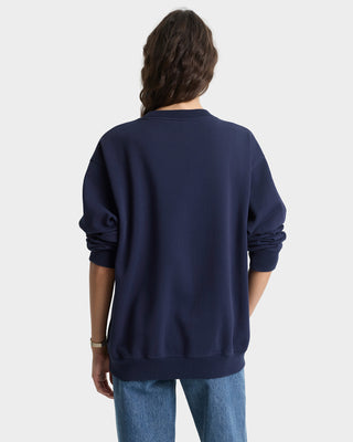 Person wearing a navy blue sweatshirt on a white background