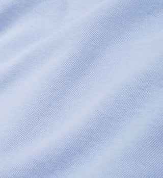 Close-up of the Health Club T-Shirt in Sky Blue/White, showing light blue fabric with visible woven texture and subtle diagonal lines, crafted from USA-grown cotton.