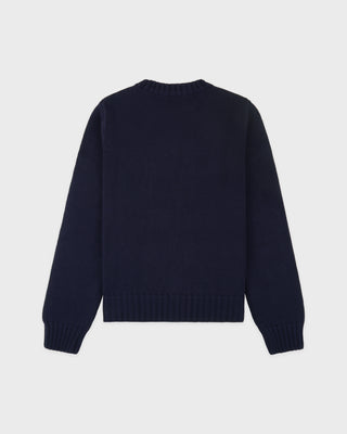 Navy blue sweater on a light gray background