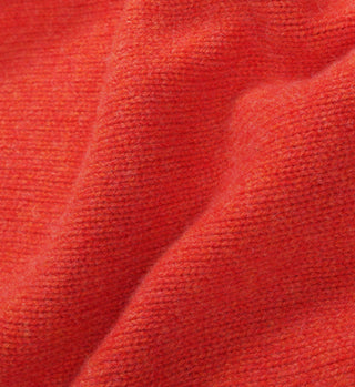 Close-up of cherry red, textured lambswool knit with visible fibers and gentle folds—crafted in Italy for the SRC Wool Crewneck.