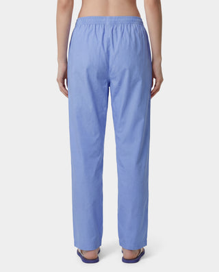 Person wearing light blue pants on a white background