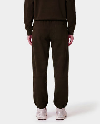 Person wearing a brown tracksuit on a white background