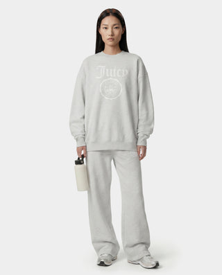 Person wearing a gray tracksuit with a logo on a white background