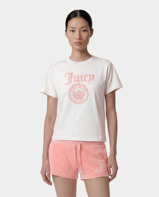 Woman wearing a white t-shirt with 'Juicy' logo and pink shorts on a white background