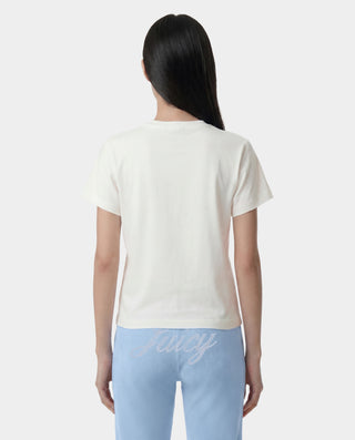 woman wearing a white t-shirt and light blue pants with 'Kitty' text on a plain background