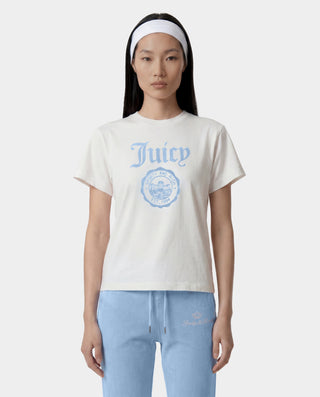 woman wearing a white t-shirt 'Juicy Couture ' logo and light blue pants on a white background