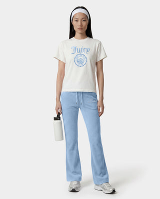 woman wearing a white t-shirt with a logo and light blue jeans on a white background