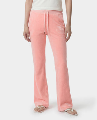 woman wearing pink juicy couture sweatpants on a white background