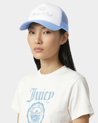 Person wearing a blue cap and white t-shirt with 'Juicy' branding on a light gray background