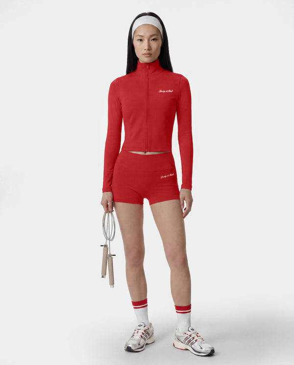 Person wearing a red athletic outfit with a white background