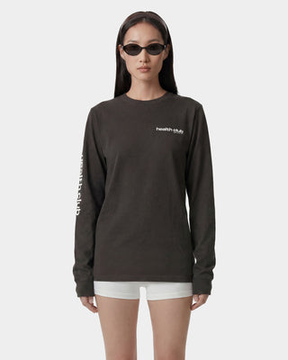 Person wearing a black long-sleeve shirt with 'health club' text on a white background