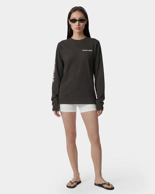 Person wearing a black long-sleeve shirt and white shorts on a white background