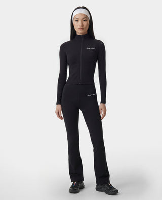 Person wearing a black athletic outfit on a white background