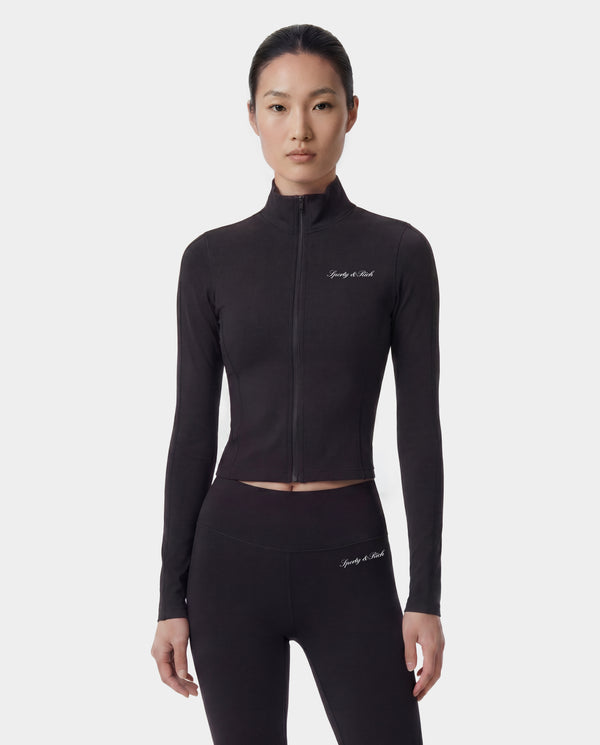 Woman wearing a black athletic outfit with branding on a white background