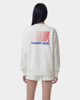 Person wearing a white sweatshirt with 'health club' text on the back against a white background