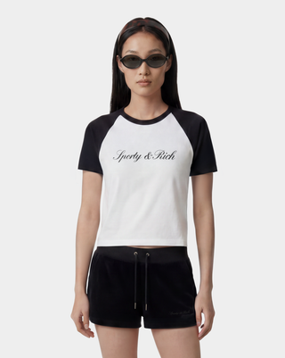 Model wearing a black and white 'Sporty & Rich' t-shirt on a white background