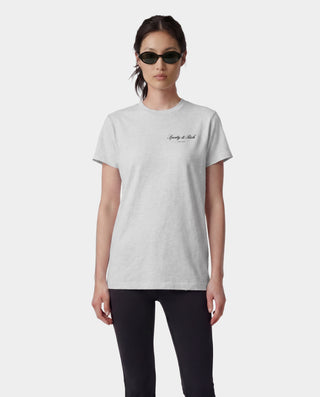 Person wearing a light gray t-shirt with text on a white background
