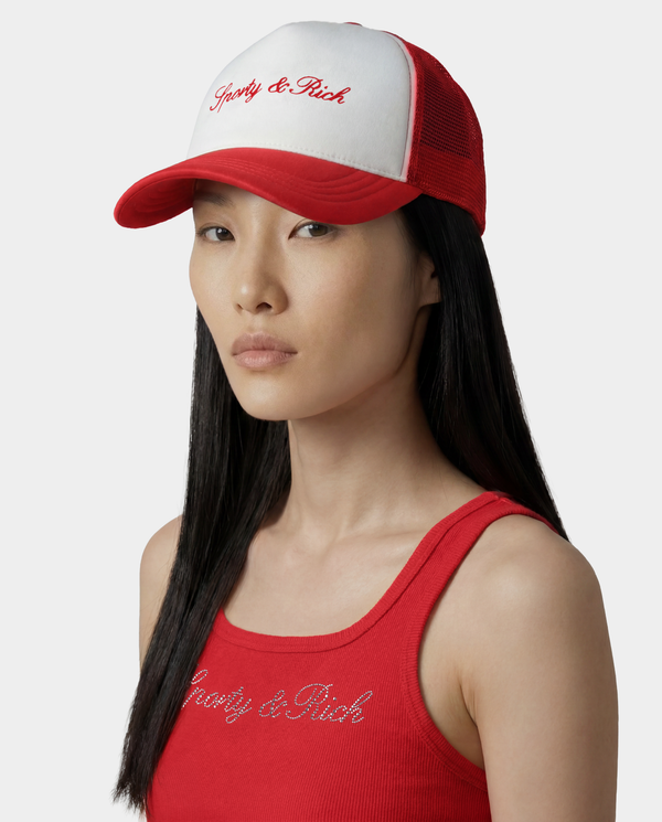 Woman wearing a red and white cap and tank top with 'Poorly & Rich' text on a white background