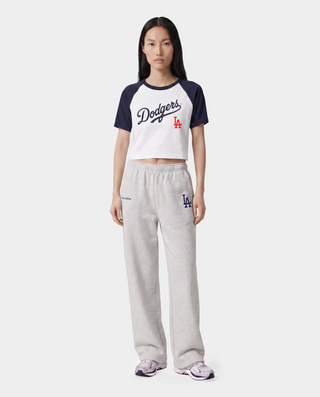 Dodgers Serif Baby Baseball Tee in White, Dark Navy, and Fire Red—crafted from 100% cotton, this stylish cropped raglan shirt features bold Dodgers text and a red LA logo on the front.