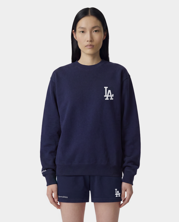 Introducing the LA Serif Crewneck in Dark Navy/White, a 100% cotton crewneck sweatshirt featuring a white LA logo on the upper left chest.