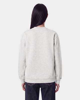 The LA Serif Crewneck in Heather Gray/Navy is a light gray crewneck sweatshirt featuring a classic navy blue LA logo on the left chest. Crafted from 100% cotton, this oversized-fit sweatshirt combines comfort and style, and is showcased against a white background.