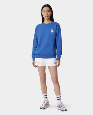 LA Serif Crewneck - Team Blue/White, an oversized crewneck crafted from 100% cotton in team blue, features a white LA logo on the left chest and is displayed laid flat on a white background.