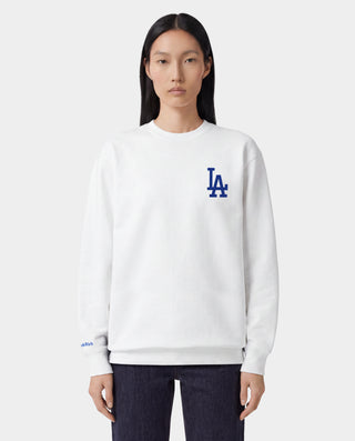 LA Serif Crewneck - White/Team Blue features an oversized fit and is made from 100% cotton, showcasing a blue LA logo on the upper left chest. Displayed on a plain light gray background.