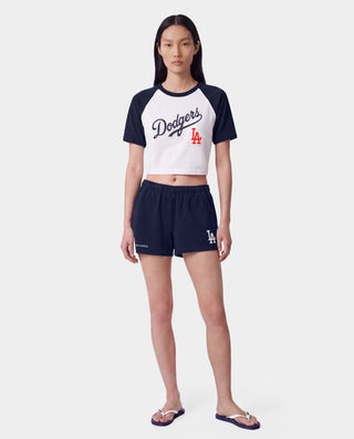 The LA Serif Disco Short in Dark Navy/White is a pair of super-short, cotton fleece shorts featuring Sports&Rich and LA logos on the front, made in the USA and displayed laid flat on a white background.