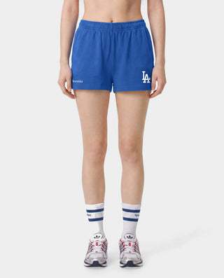 Introducing the LA Serif Disco Short in Team Blue/White—crafted from athletic cotton fleece and featuring an elastic waistband. These shorts showcase "Sports & Rich" alongside a striking white LA logo on the front, displayed laid flat against a white background. Proudly made in the USA.