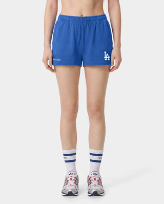 Introducing the LA Serif Disco Short in Team Blue/White—crafted from athletic cotton fleece and featuring an elastic waistband. These shorts showcase "Sports & Rich" alongside a striking white LA logo on the front, displayed laid flat against a white background. Proudly made in the USA.