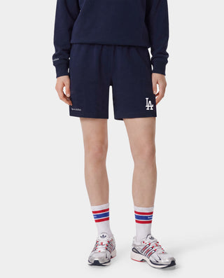 Dodgers Serif Gym Short in Dark Navy/White, featuring LA and Sporty & Rich logos on the front, an elastic waistband, crafted from 100% cotton in Portugal. Presented against a white background.