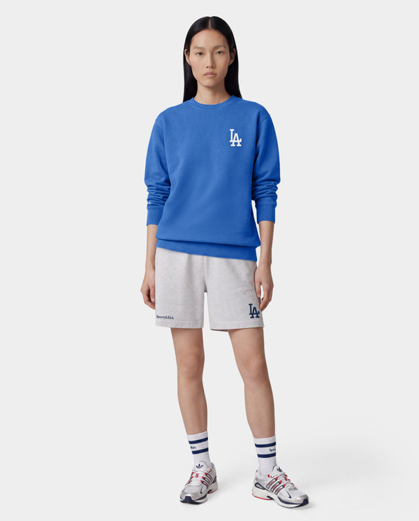 Dodgers Serif Gym Short in Heather Gray/Navy features an elastic waistband, side pockets, and navy Sporty & Rich and LA logos on the legs. Made in Portugal from 100% cotton for comfort and style.