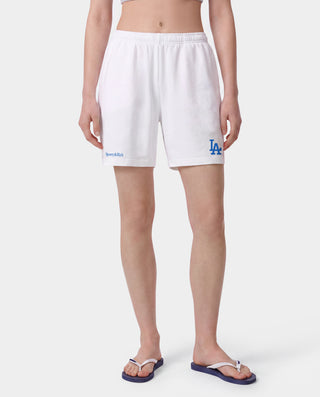 Dodgers Serif Gym Short - White/Team Blue, white athletic jersey shorts featuring Sporty & Rich and LA logos in team blue on the front, made from 100% cotton with an elastic waistband, displayed on a gray background.