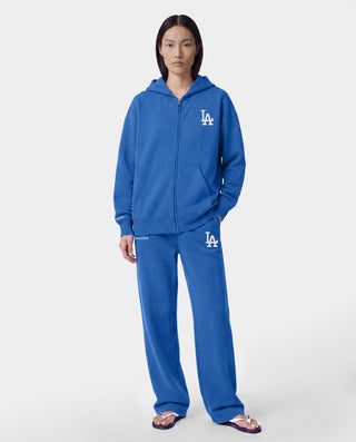 The LA Serif Wide Sweatpant in Team Blue/White features wide legs and showcases Sports Rich and LA logos on the front, crafted from soft cotton and displayed against a plain white background.