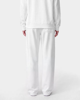 LA Serif Wide Sweatpant - White/Team Blue, crafted in Portugal from 100% cotton, features a wide-leg silhouette with blue LA and Sports Rich logos and is displayed on a plain light gray background.