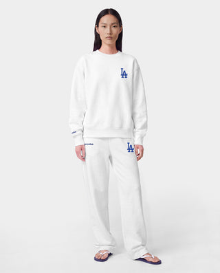 LA Serif Wide Sweatpant - White/Team Blue, crafted in Portugal from 100% cotton, features a wide-leg silhouette with blue LA and Sports Rich logos and is displayed on a plain light gray background.