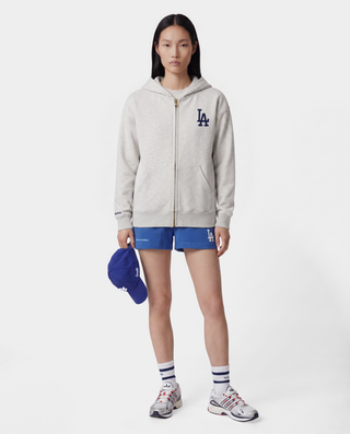 LA Serif Zip Hoodie in Heather Gray/White, featuring a zipped front, LA logo on the chest, front pockets, and crafted from 100% cotton in an oversized fit, shown laid flat on a white background.