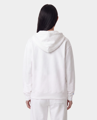 The LA Serif Zip Hoodie - White/Navy features a white zip-front design, crafted from 100% cotton, with a blue LA logo on the left chest and a front pocket, displayed against a plain background.