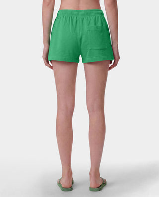 Green athletic shorts with an elastic waistband and a small white 'Sporty & Co.' logo on the lower left leg, shown flat against a light gray background.
